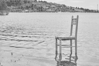 Chairs on beach by lake
