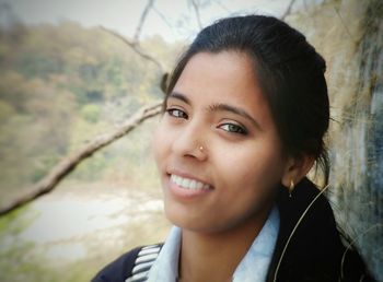 Close-up portrait of smiling young woman