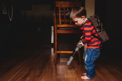 Boy standing on hardwood floor at home
