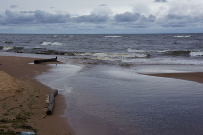 Scenic view of sea against cloudy sky