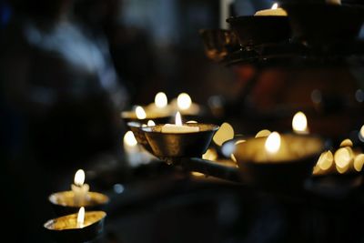 Close-up of lit candles in temple