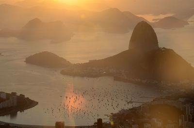 High angle view of silhouette mountains during sunrise