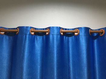 High angle view of leather hanging against blue background