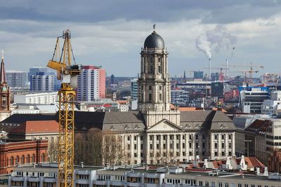 Cityscape against cloudy sky