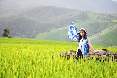 Portrait of smiling young woman on land