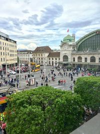 Tourists at town square against sky