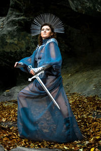 Rear view of woman standing in forest