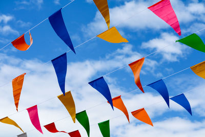 Low angle view of flags against sky