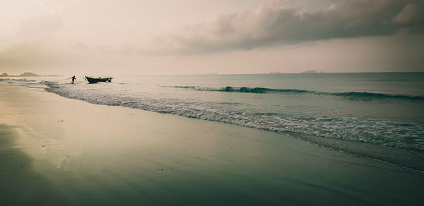 Scenic view of beach against sky during sunset