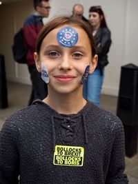 Portrait of happy boy standing against wall