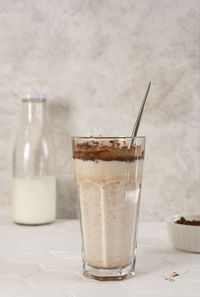 Delicious homemade cocoa drink with milk and cocoa powder. vertical orientation.