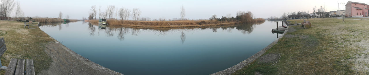 Panoramic view of lake in city against sky