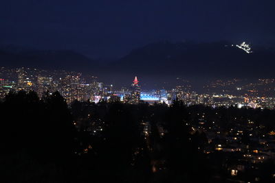 High angle view of city lit up at night