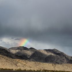 Scenic view of mountains against rainbow