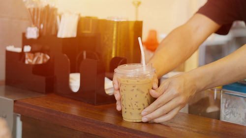 Cropped hand of woman preparing food on table