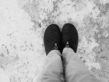 Low section of woman standing on concrete floor