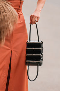 Midsection of woman standing against white background