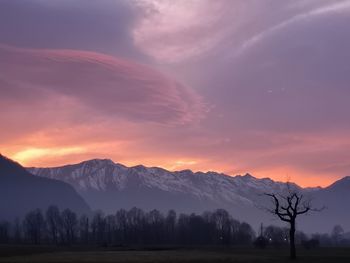 Scenic view of snowcapped mountains against sky during sunset