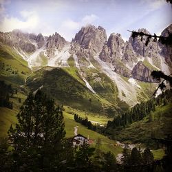 Scenic view of mountains against cloudy sky