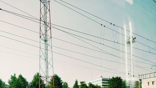 Low angle view of electricity pylon against sky