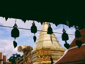 Low angle view of decorations hanging against wat phrathat doi suthep