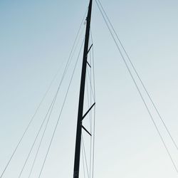 Low angle view of mast against clear sky on sunny day