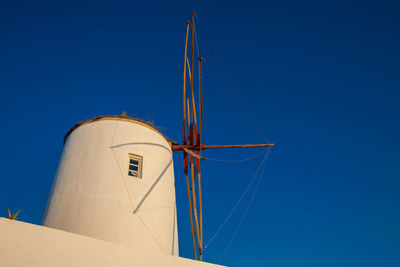 Antique traditional windmills in the city of oia at santorini island