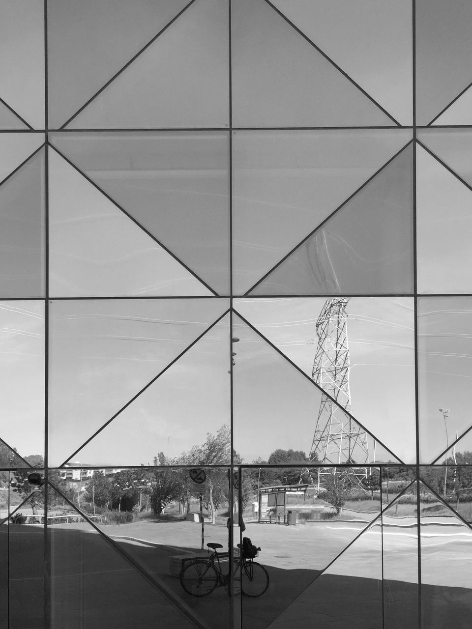 DIGITAL COMPOSITE IMAGE OF GLASS BUILDING WITH REFLECTION