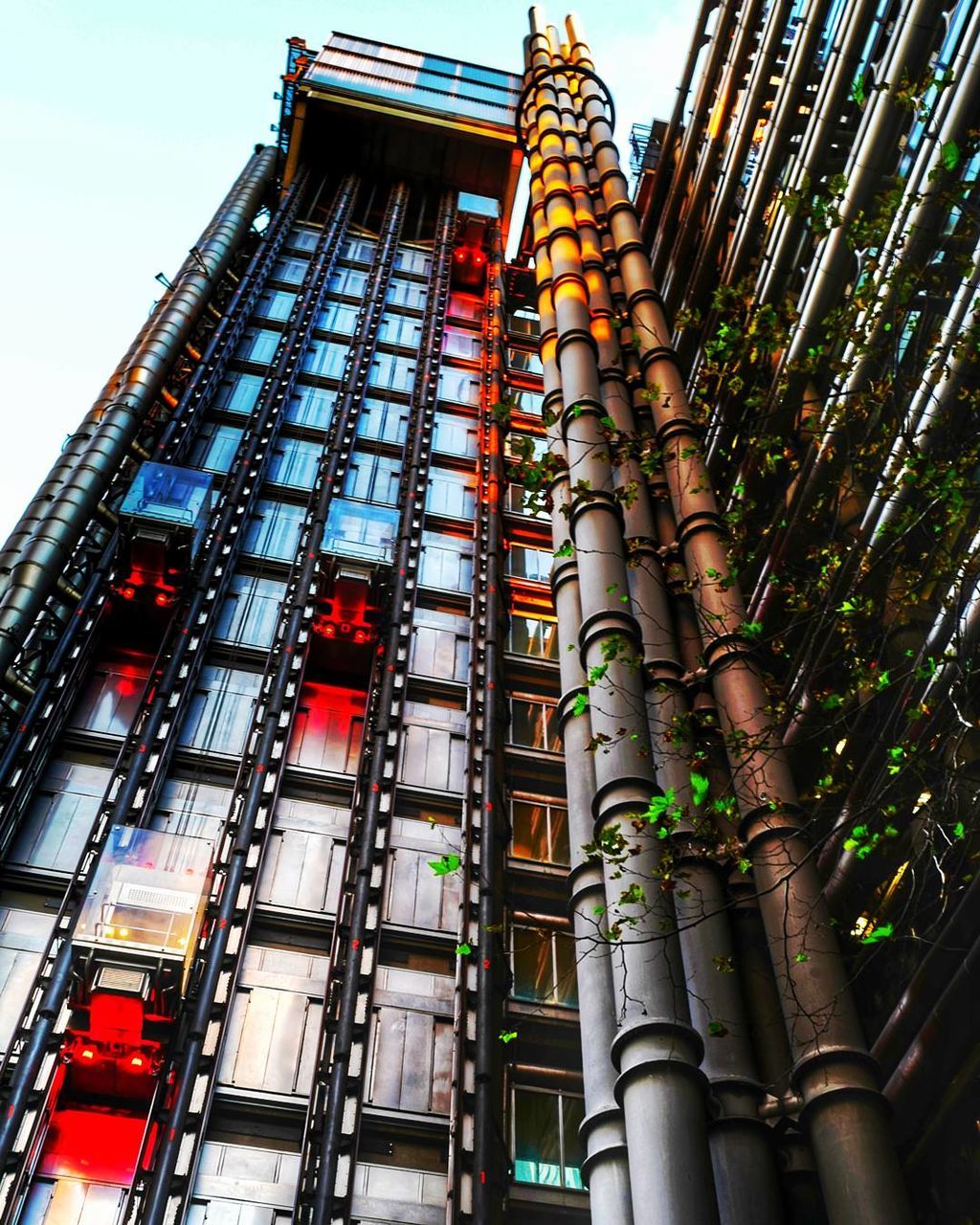 low angle view, built structure, architecture, building exterior, pipe - tube, no people, outdoors, day, modern, city, sky