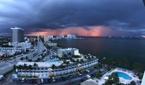High angle view of illuminated buildings in city at sunset