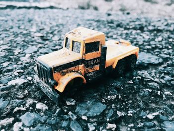 Close-up of toy car on old road