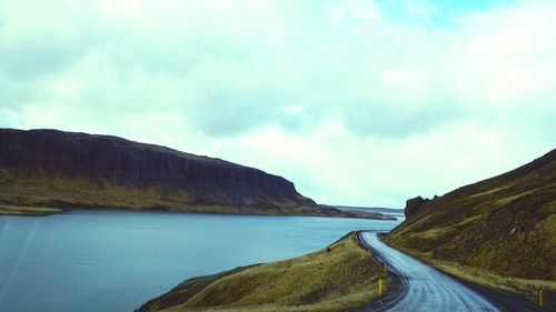 Panoramic view of road by sea against sky