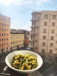 Close-up of food on building in city against sky