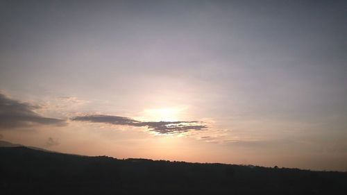 Scenic view of silhouette mountain against sky at sunset