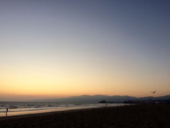 Scenic view of sea against clear sky during sunset