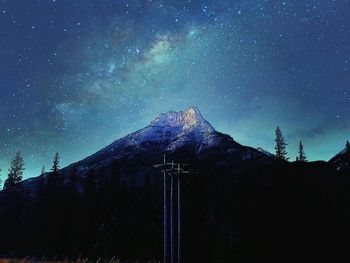 Low angle view of mountain range against blue sky
