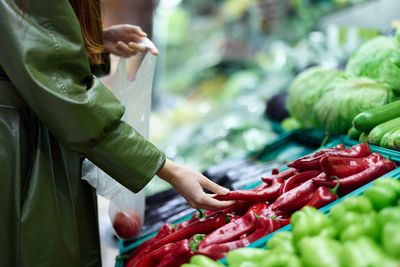 Midsection of man holding vegetables