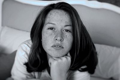 Portrait of happy girl sitting on floor