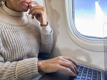 Midsection of woman using laptop