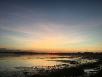 Scenic view of lake against sky during sunset