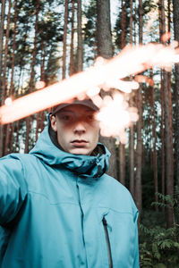 Portrait of young man in forest