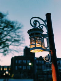 Low angle view of illuminated street light against sky