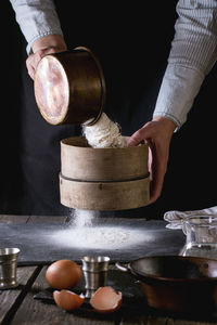 Midsection of man preparing food