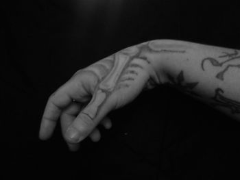 Close-up of human hand against black background