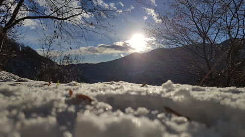 Close-up of snow on mountain against sky