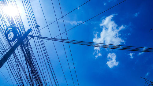 Low angle view of cables against blue sky