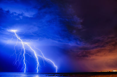 Lightning over sea against sky