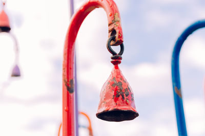 Close-up of red leaf hanging on metal