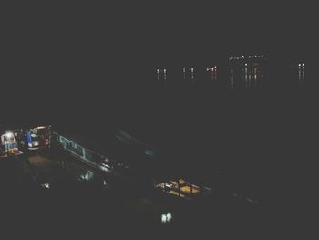 Illuminated city against sky at night