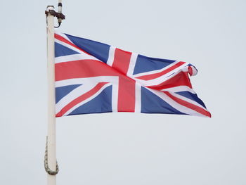 Low angle view of flag against clear sky